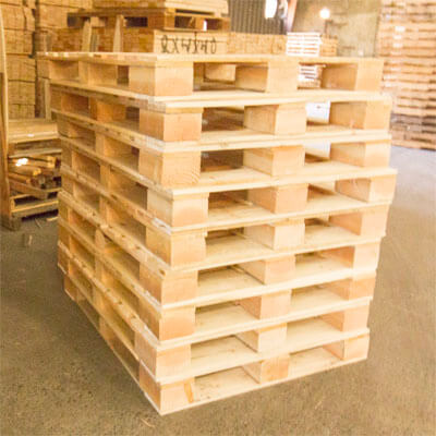 A stack of wooden 9 block grade pallets.