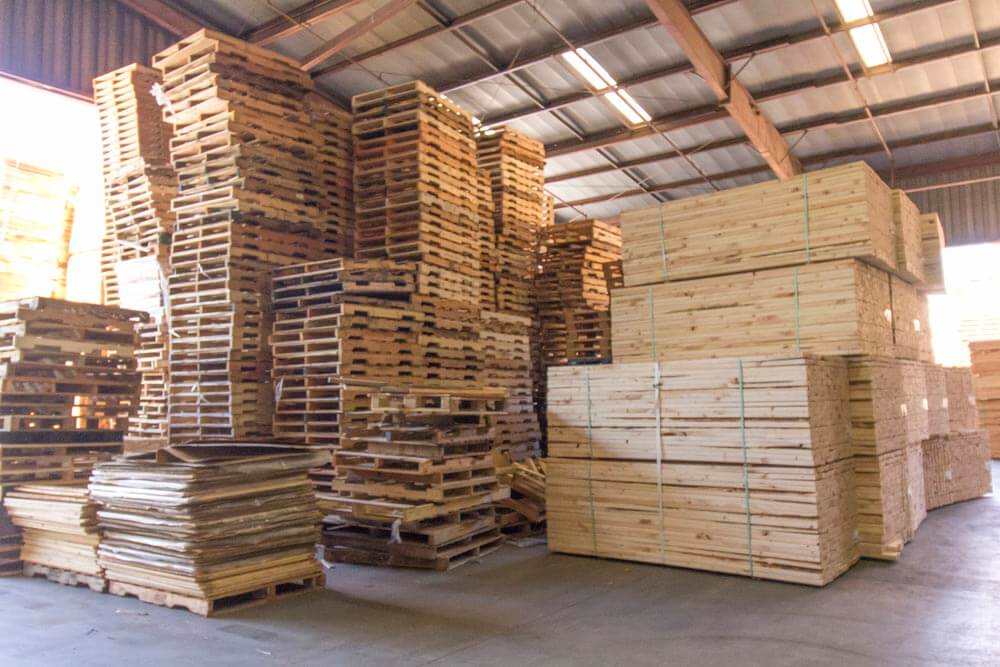 Warehouse full of pallets and packed lumber.
